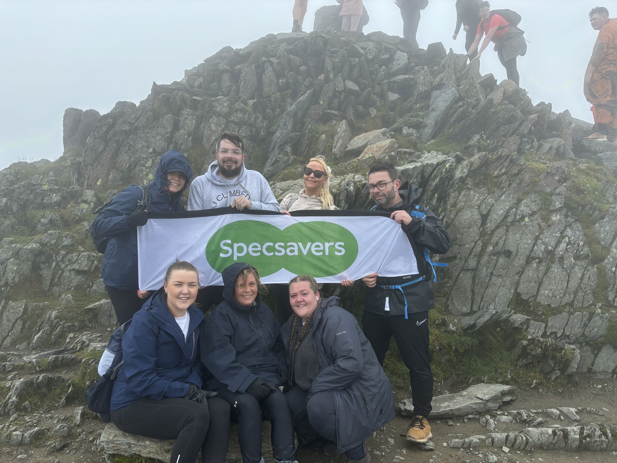 A group of fundraisers from Specsavers climbing Ben Nevis.