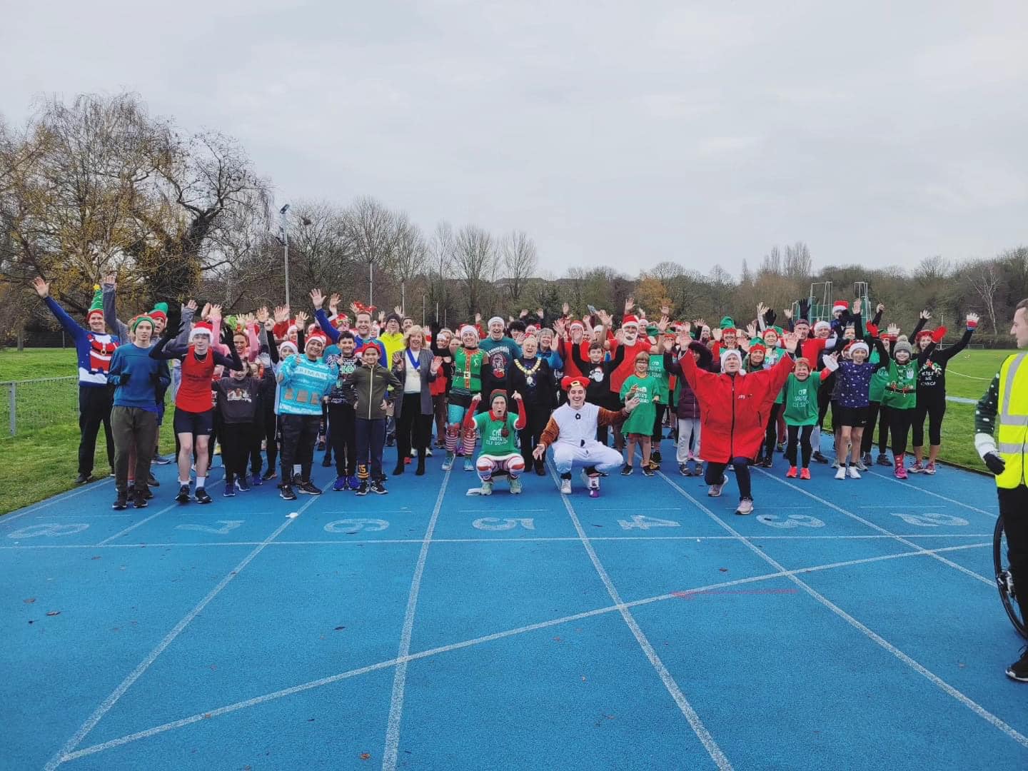 a group of people standing in christmas fancy dress ready to start running